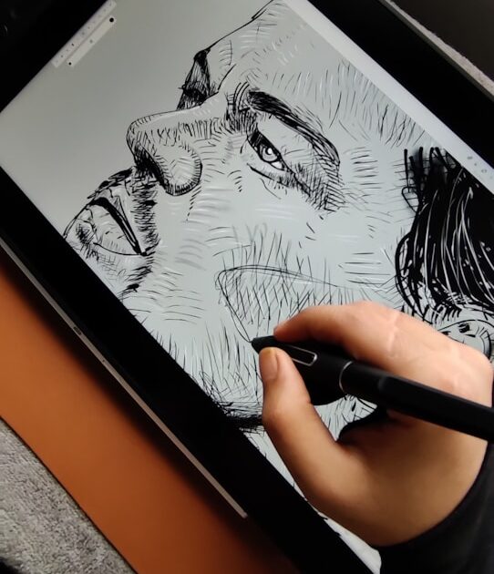 a person is drawing on a tablet with a pen